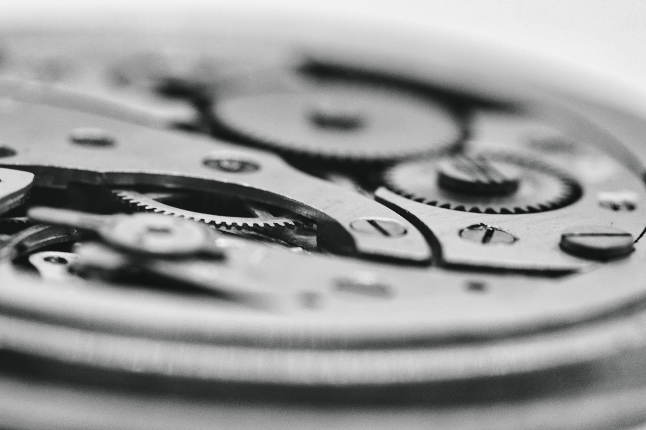 Close-up of the wheels, bridges and screws of a mechanical movement.